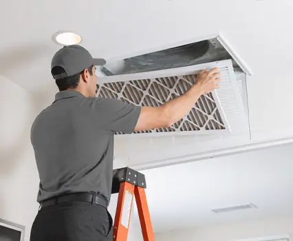 Air vent cleaning technician removing debris